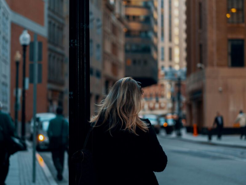 photo of the back of a women out in a city downtown